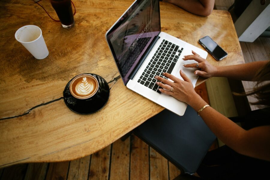 Person reading laptop notebook coffee