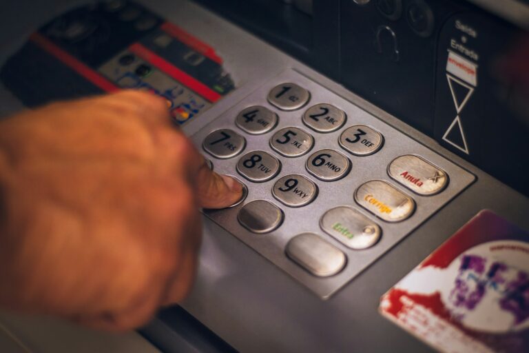 Person using atm keypad