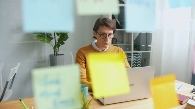 Copywriter notes sticky notes laptop freelance writer working