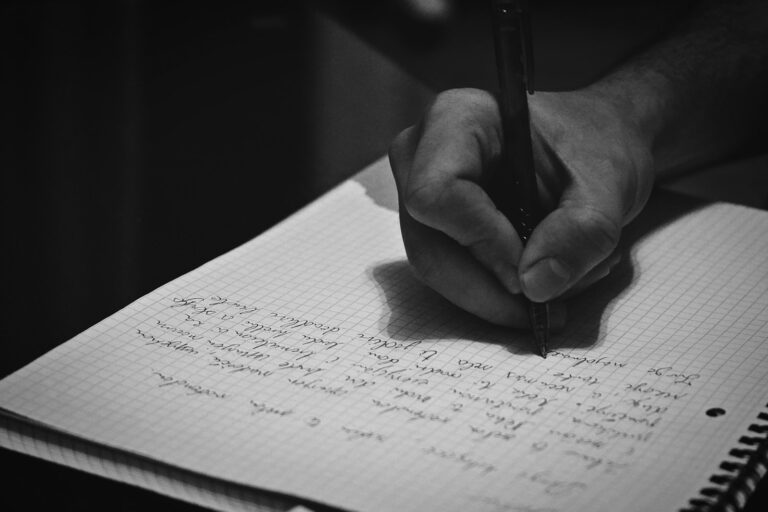 Hand writing expenses notebook
