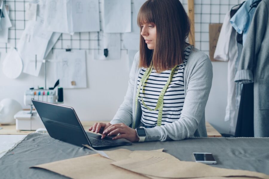Small business owner laptop paperwork