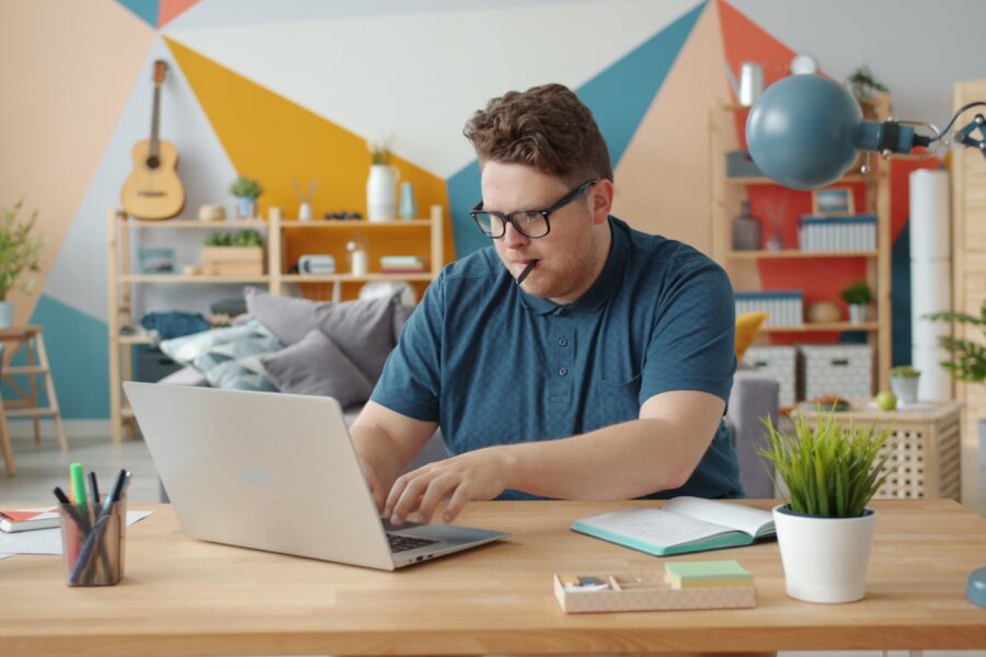 Photographer working laptop camera home office