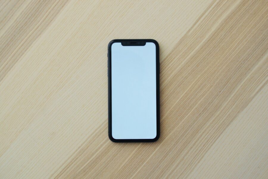 Smartphone banking app debit card wooden table