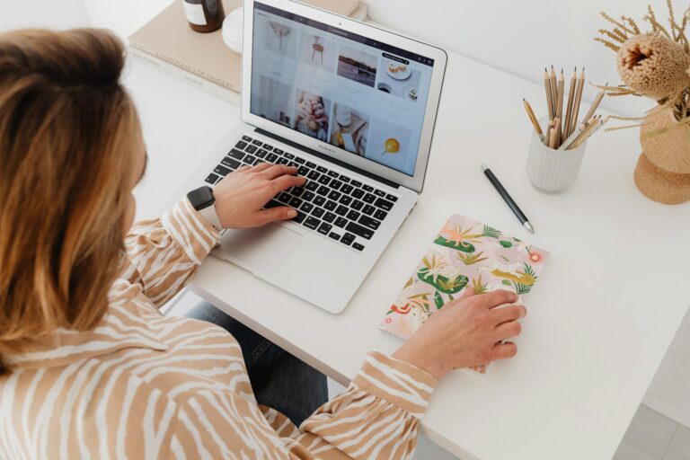 Home office desk calendar pen laptop person writing