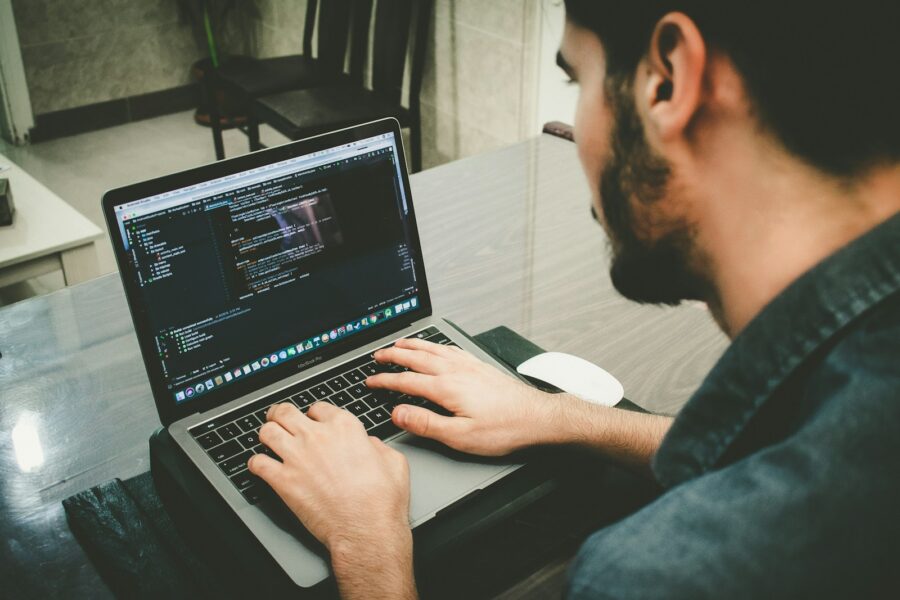 Person editing resume laptop desk