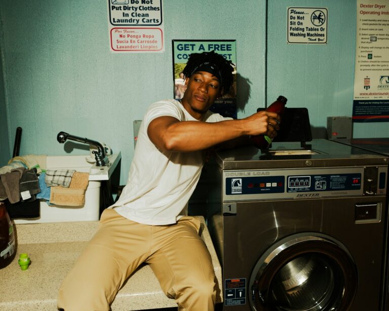 Appliance technician repairing washing machine