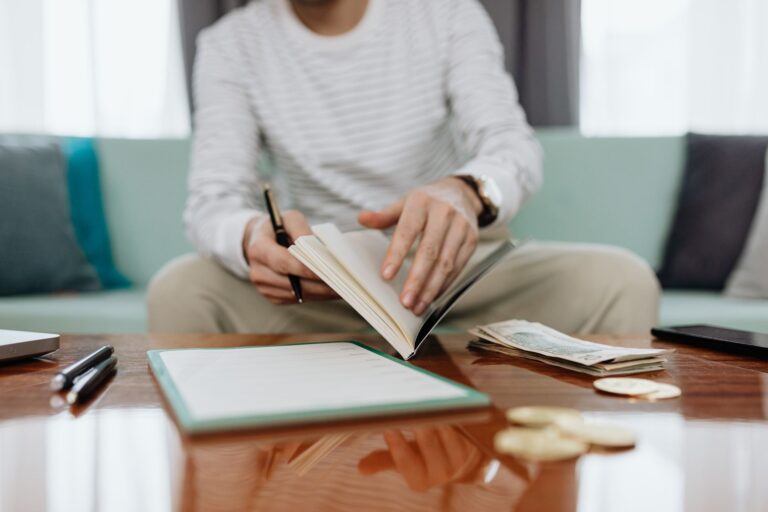 Person reviewing investment statements notebook
