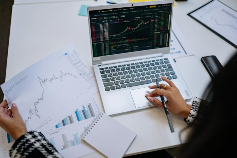 Person laptop etf chart financial graphs