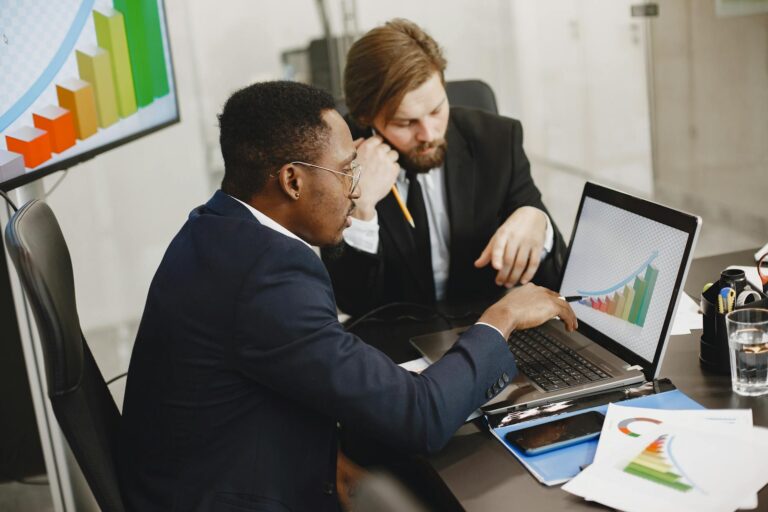 Office workers financial charts laptop