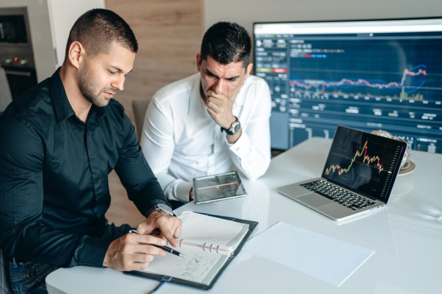 Investor reviewing charts laptop coffee table