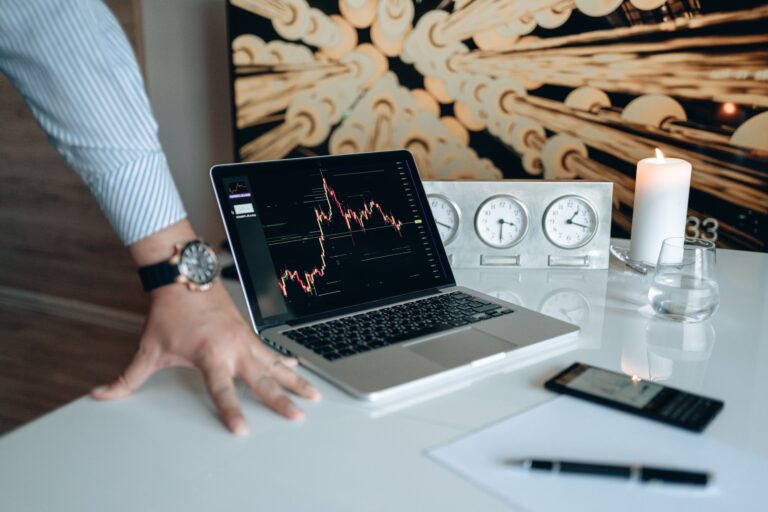 Investor reviewing charts laptop coffee table