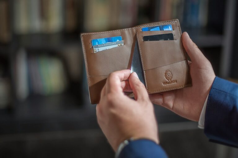 Person holding secured credit card wallet table