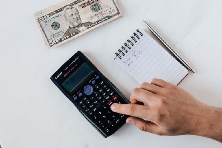 Calculator notepad coffee table budgeting bank building entrance