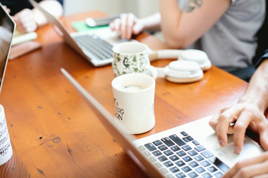 Person checking finances notebook laptop coffee table