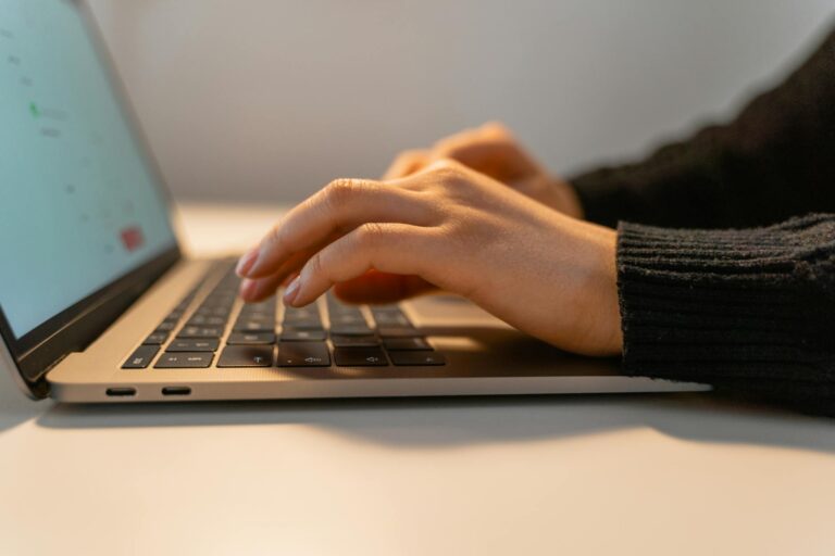 Person typing transcription software screen