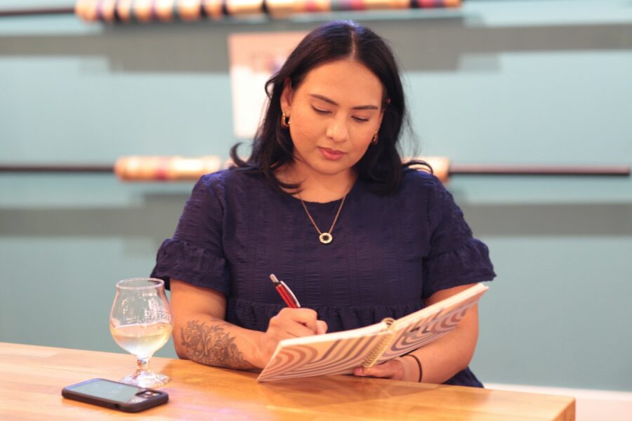 Woman shopping notebook pen receipts table