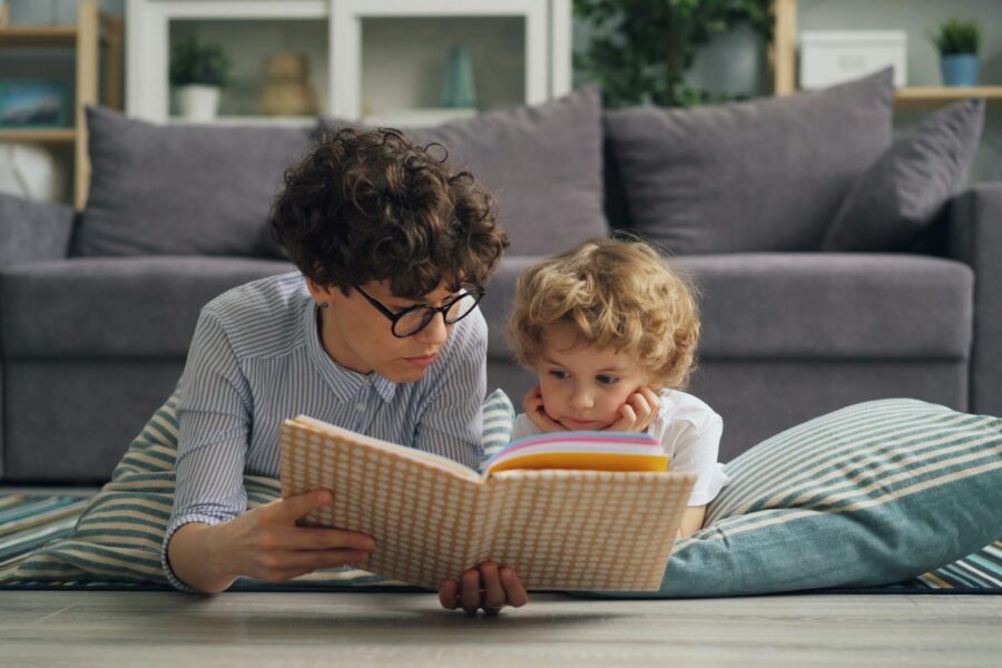 Babysitter reading book child living room