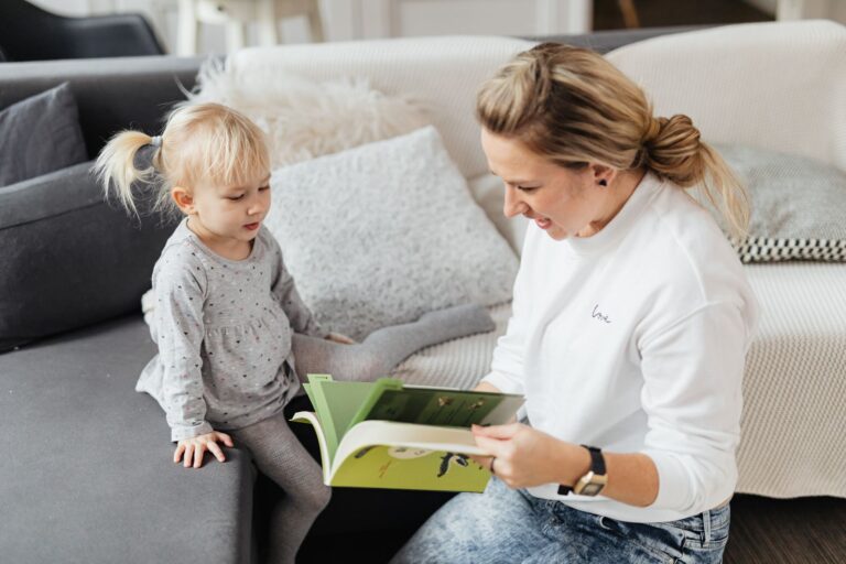 Babysitter reading book child living room