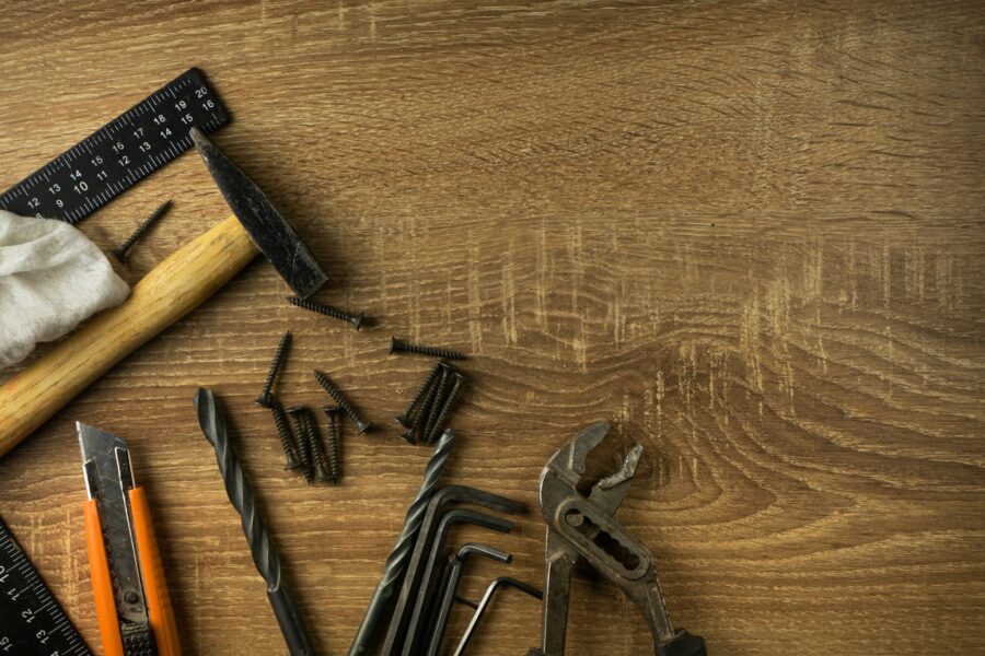 Handyman tools drill level tape measure wooden table
