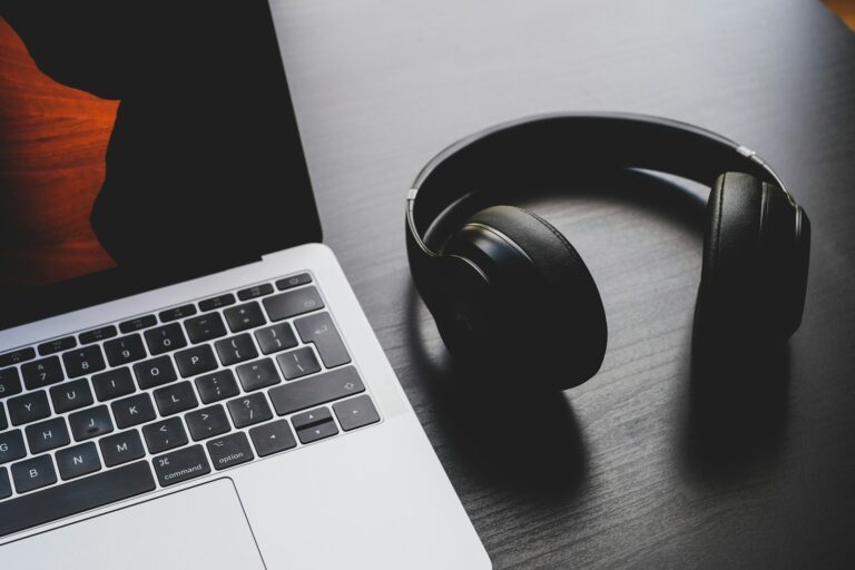 Home podcast editing desk laptop headphones