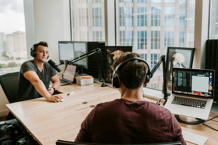 Home podcast editing desk laptop headphones