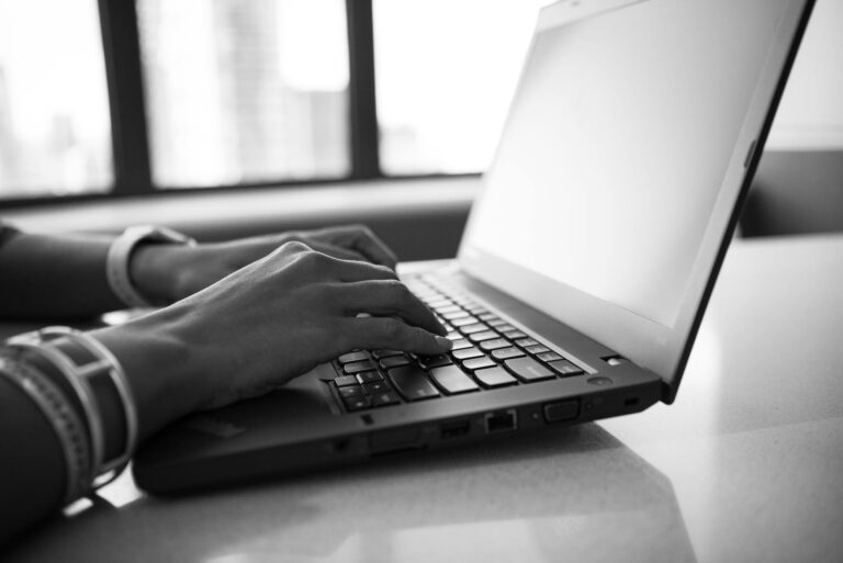 Closeup hands typing laptop microtask dashboard