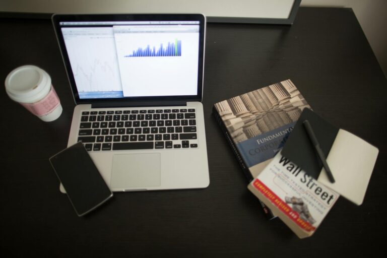 Diversified investment chart laptop coffee