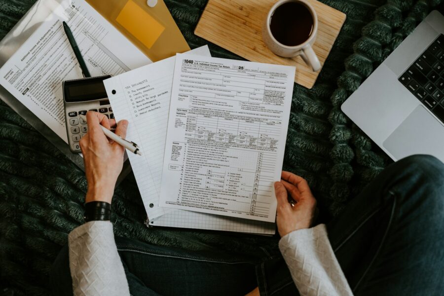 Person reviewing credit report laptop paperwork