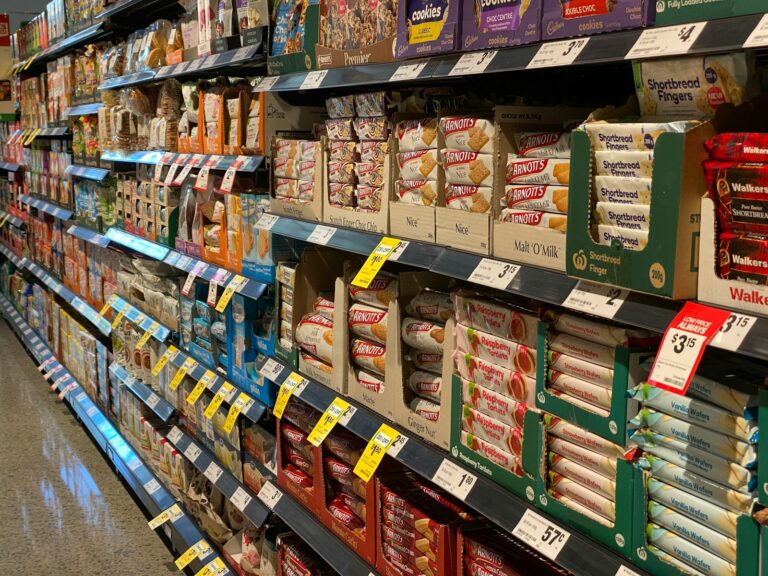 Supermarket aisle grocery shelves price labels