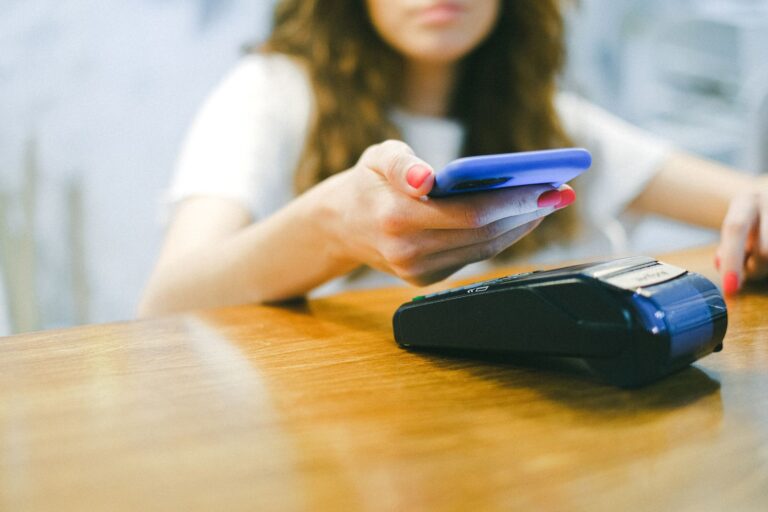 Person paying smartphone