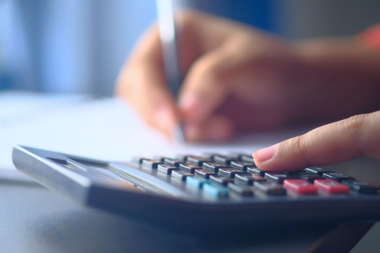 Hands writing investing